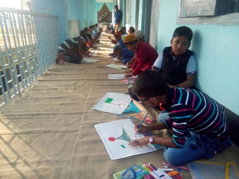 Students of an ENRICH Education Assistance Center are busy in a Drawing Competition organised to observe the Victory Day