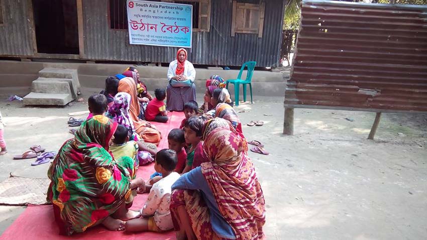 An ENRICH Health Assistant delivering health and nutrition-related messages to rural women at a yard meeting, popularly known as Uthan Boithok in Bangla