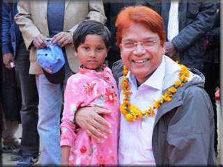 Dr Jashim Uddin poses with a girl child at Char Elahi EAC
