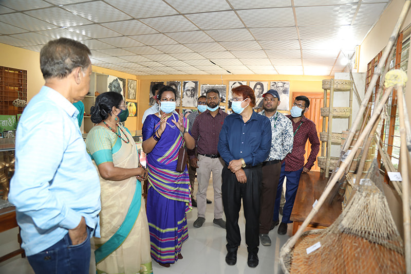 Dr Nomita Halder ndc being briefed on the collection of traditional artifacts by plainland ethnic groups in Parbatipur, Dinajpur.